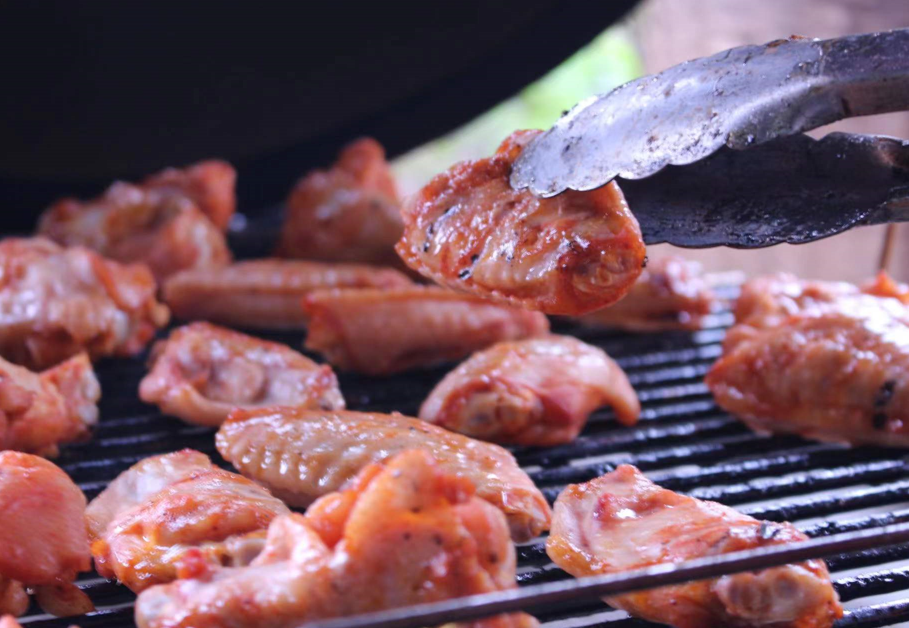 Chef preparing diverse dishes on an Outdoor Kamado grill