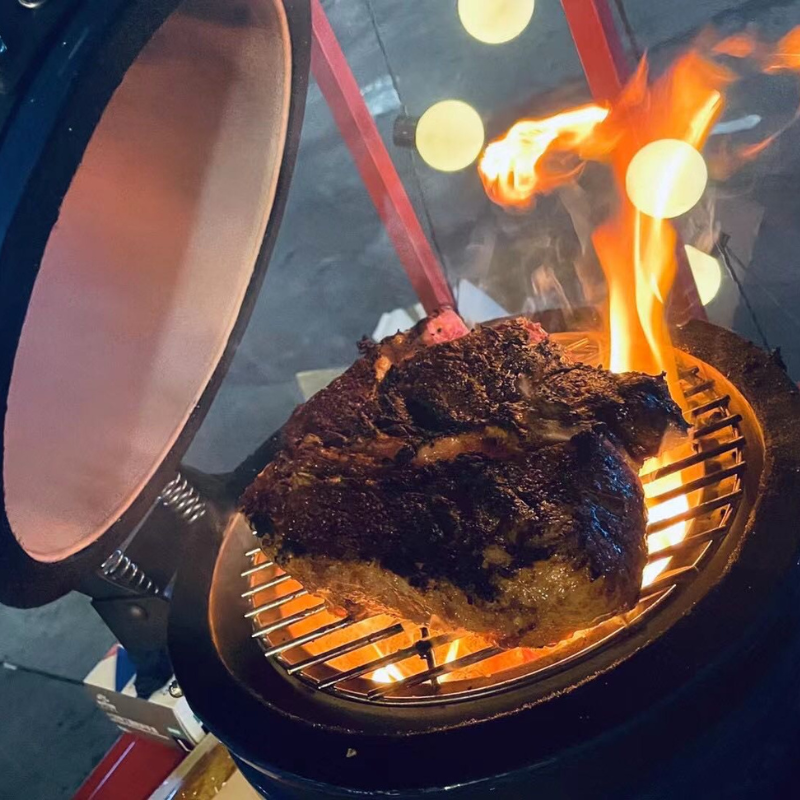 beef cooking in the kamado mini grill