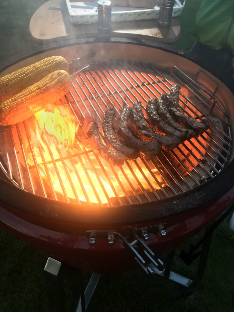 Kamado grill enhancing flavor with smoky meat cooking